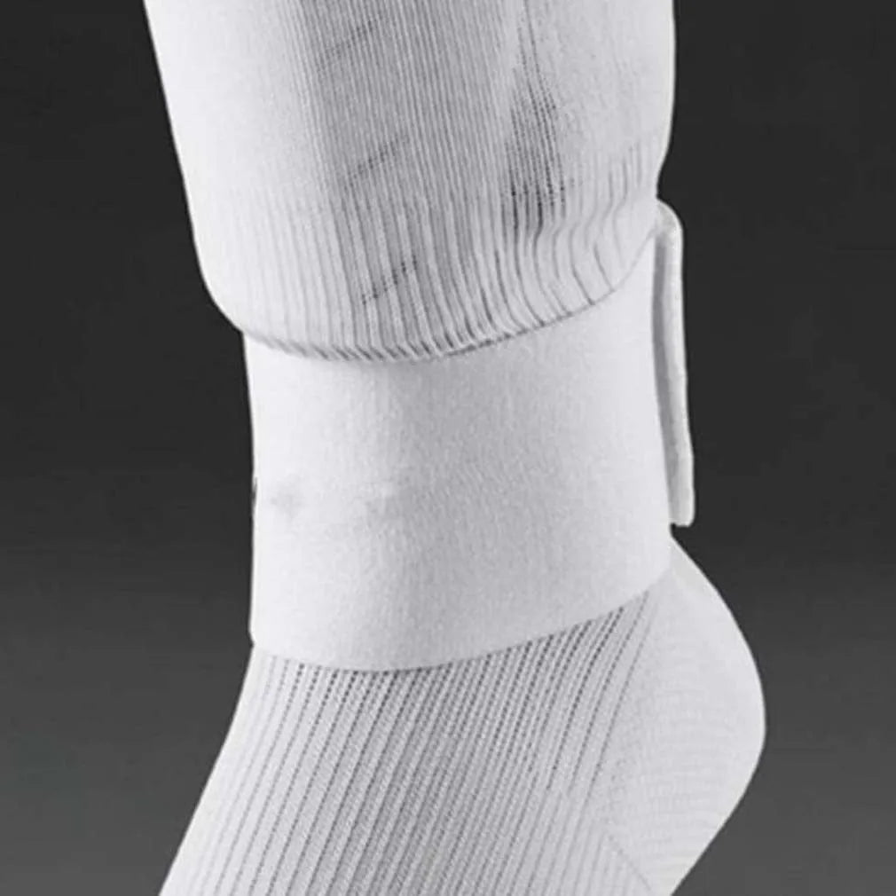 Rubber football shin guard belt in multiple colours securing protective pad on athlete's leg