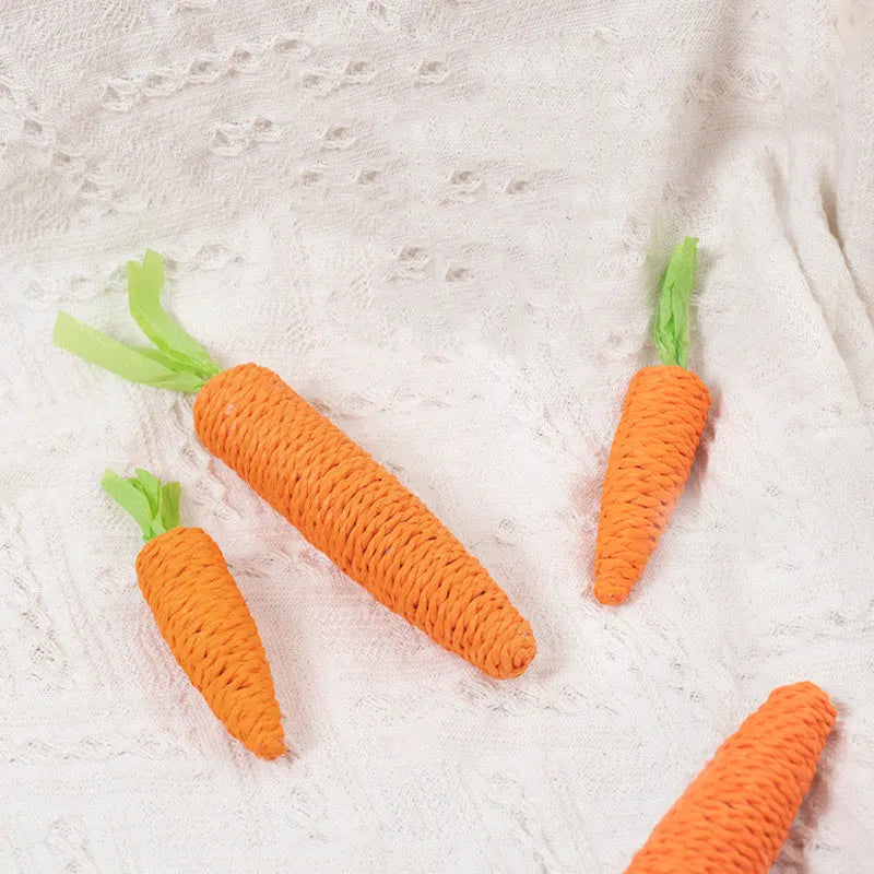 Assortment of cat toys including paper carrot bites, ringing stones, textured sticks and tooth grinding pieces in two sizes