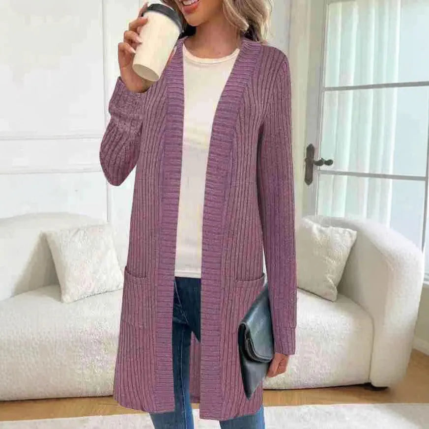 Loose fit grey knitted cardigan jacket with long sleeves and patch pockets on a hanger.