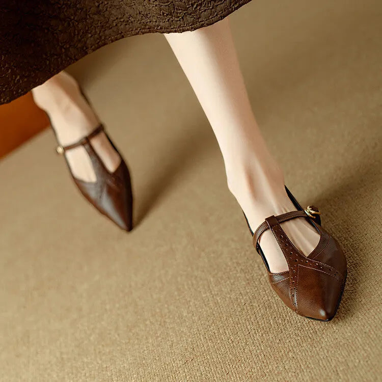 Brown women's cowhide leather flat shoes with round toe and metal detail on a soft sole.