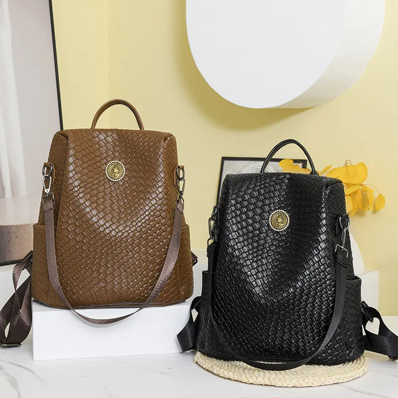 Women's black anti-theft backpack with woven details and multiple compartments