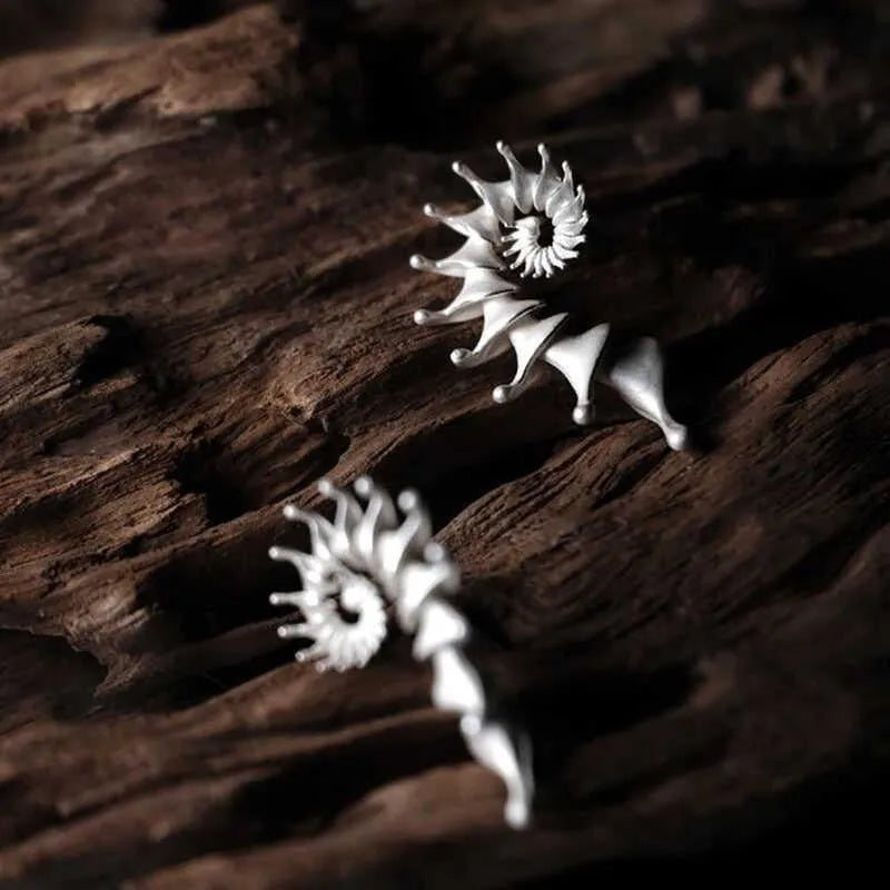 Conch coloured stud earrings with three-dimensional irregular design and matte alloy finish