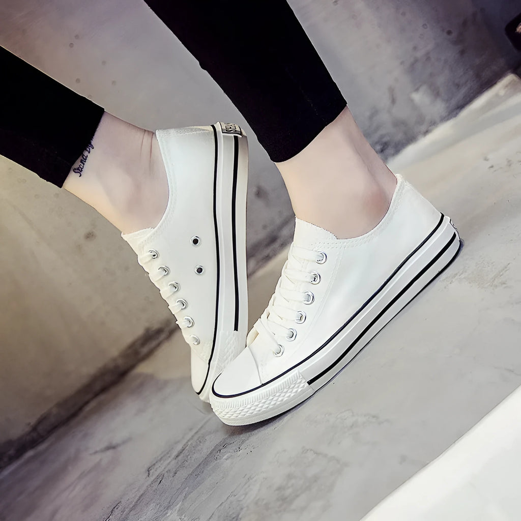 Women's casual canvas shoes in solid colours showing black, white black, white red, and all black options