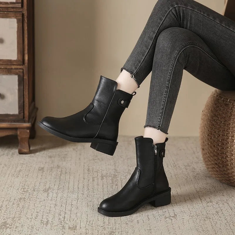 Black women's ankle boots with a side zipper, round toe, and a low rubber sole