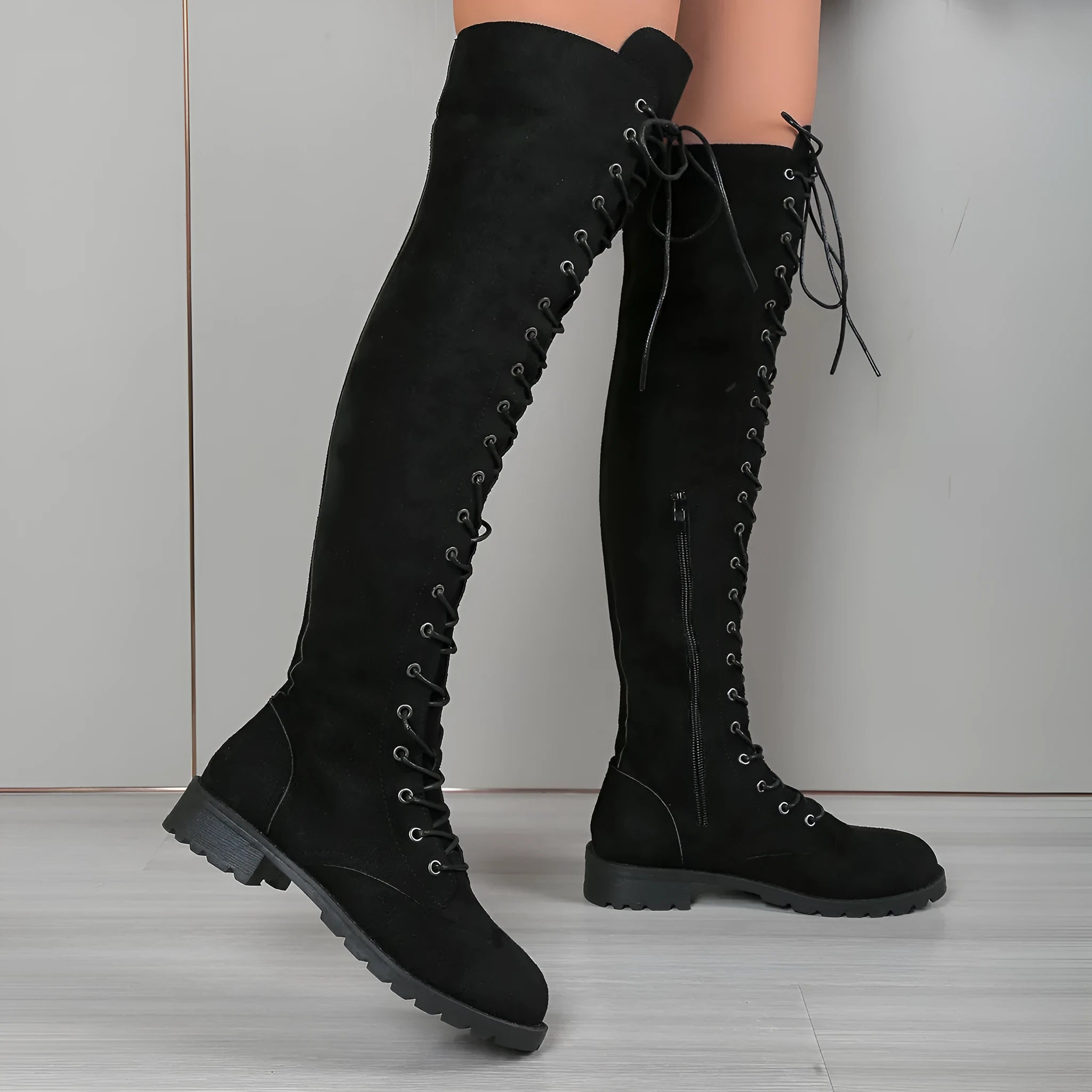 Black women's lace-up over-the-knee boots with round toe and flat heel on a white background.