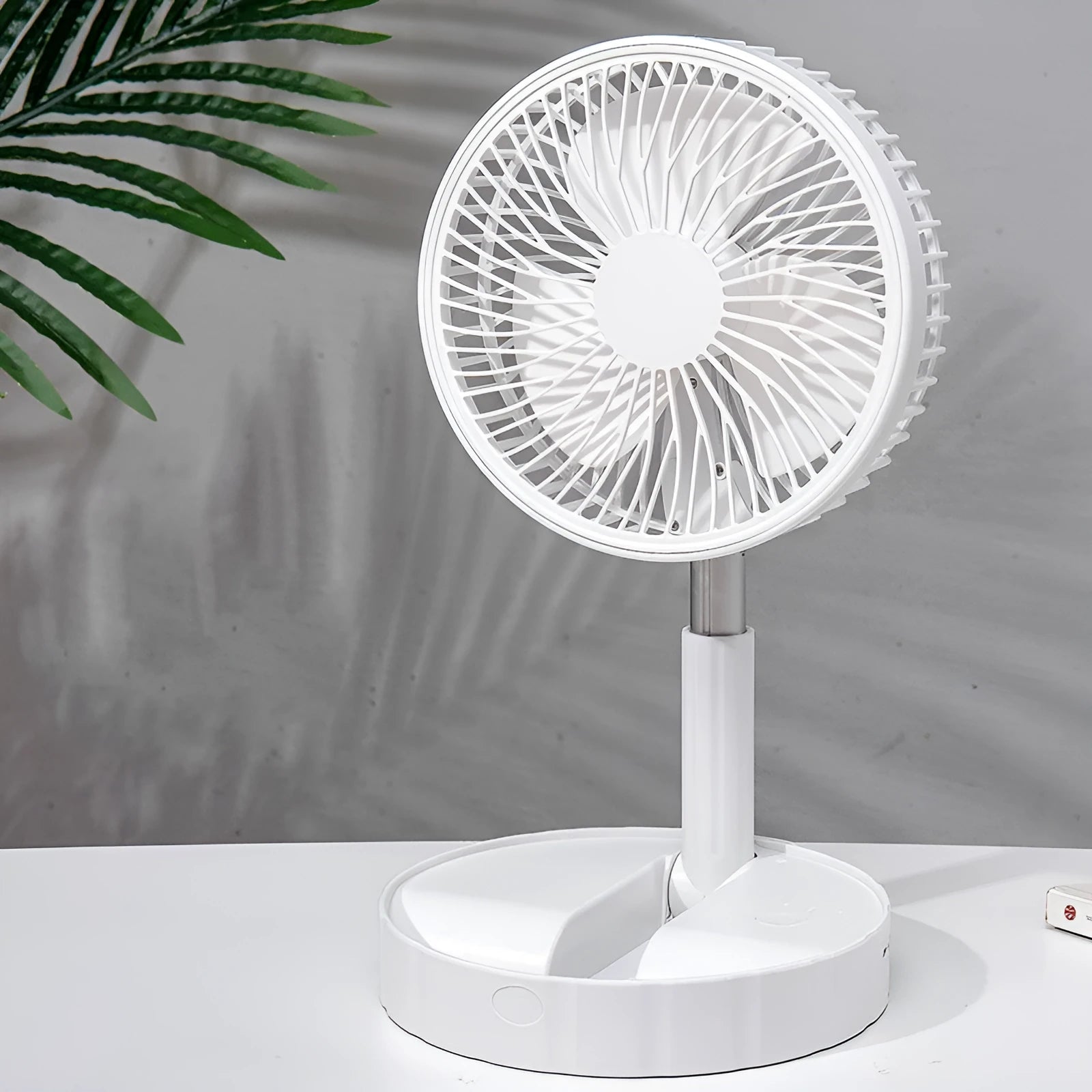 Black portable telescopic folding fan with power bank function, shown extended and folded.