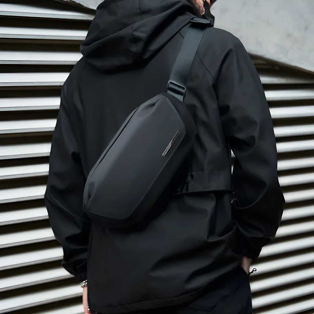 Black Oxford cloth men's messenger bag with cross-body strap.
