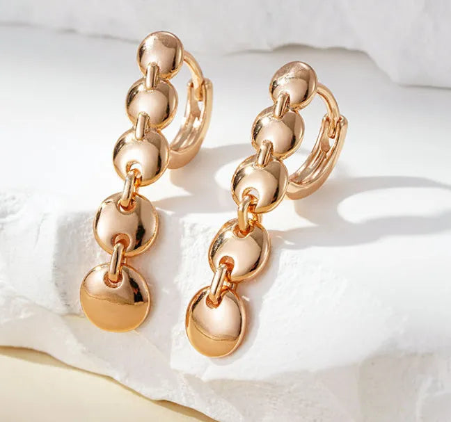 Gold-coloured retro circle earrings with 8cm diameter woven copper construction