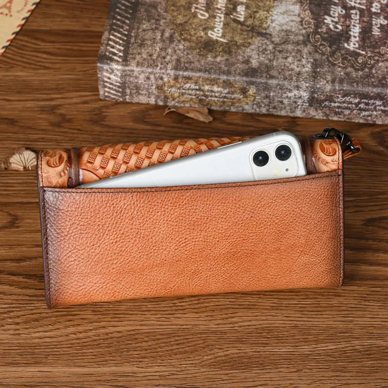 Women's brown leather tri-fold wallet with embossed Chinese floral pattern showing interior compartments