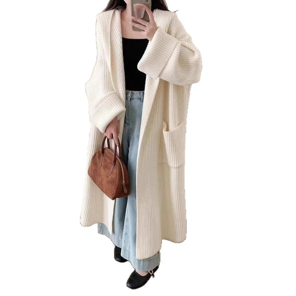 Loose grey hooded cardigan coat with raglan sleeves shown on a hanger.