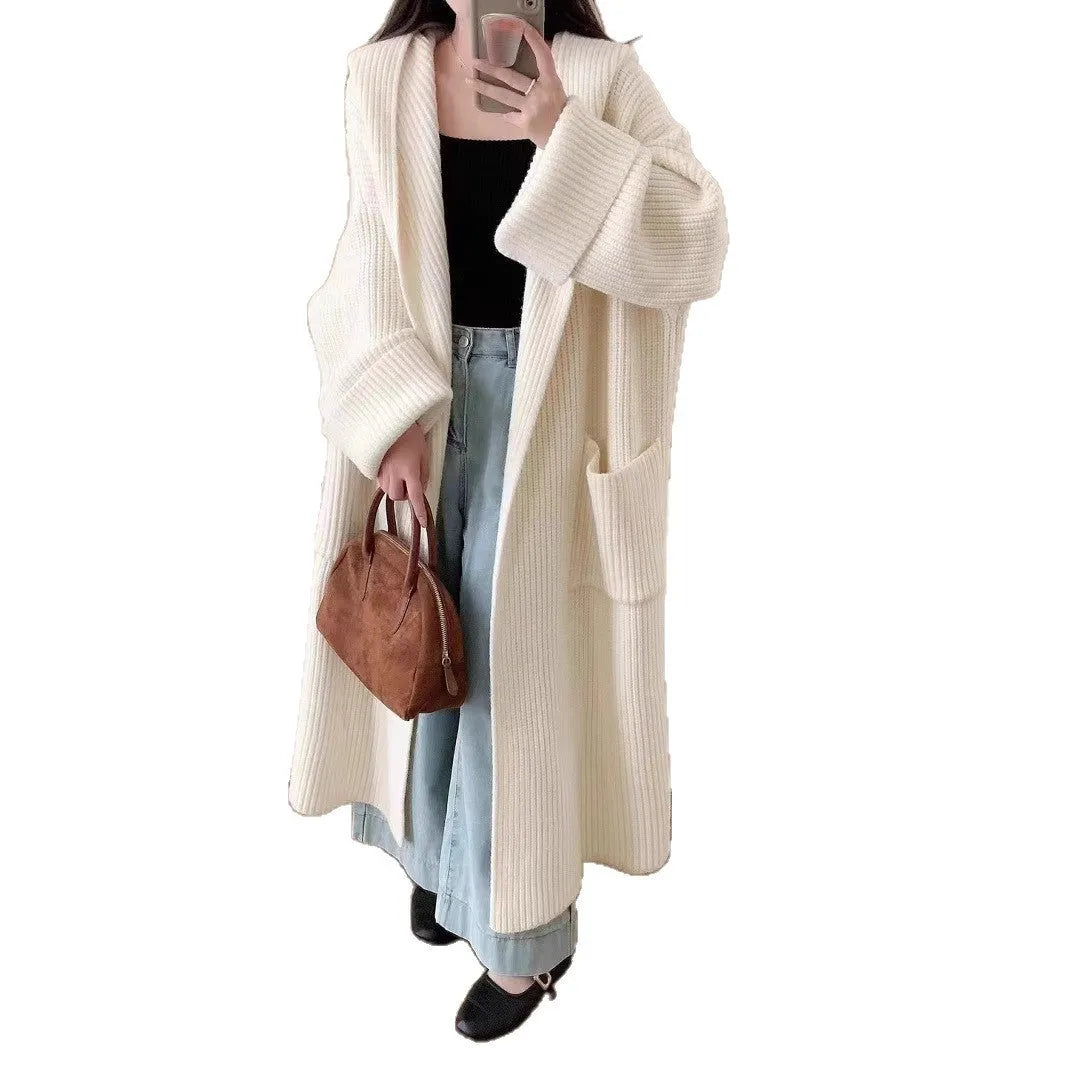 Loose grey hooded cardigan coat with raglan sleeves shown on a hanger.