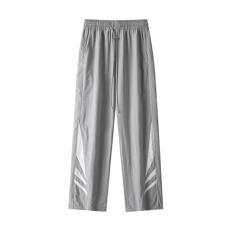 Men's black loose-fit straight-leg sports trousers for summer, shown on a hanger.