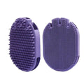 Purple massaging pet shampoo brush with soft TPR bristles, dual-sided dog grooming tool on white background