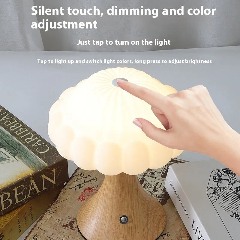 Wood grain coloured mushroom-shaped touch lamp with USB charging port on a table