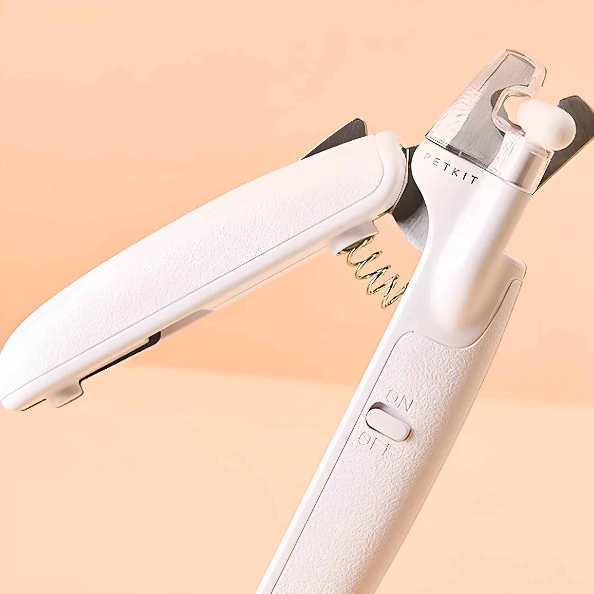 White pet nail clippers with built-in LED light and transparent anti-splash guard.