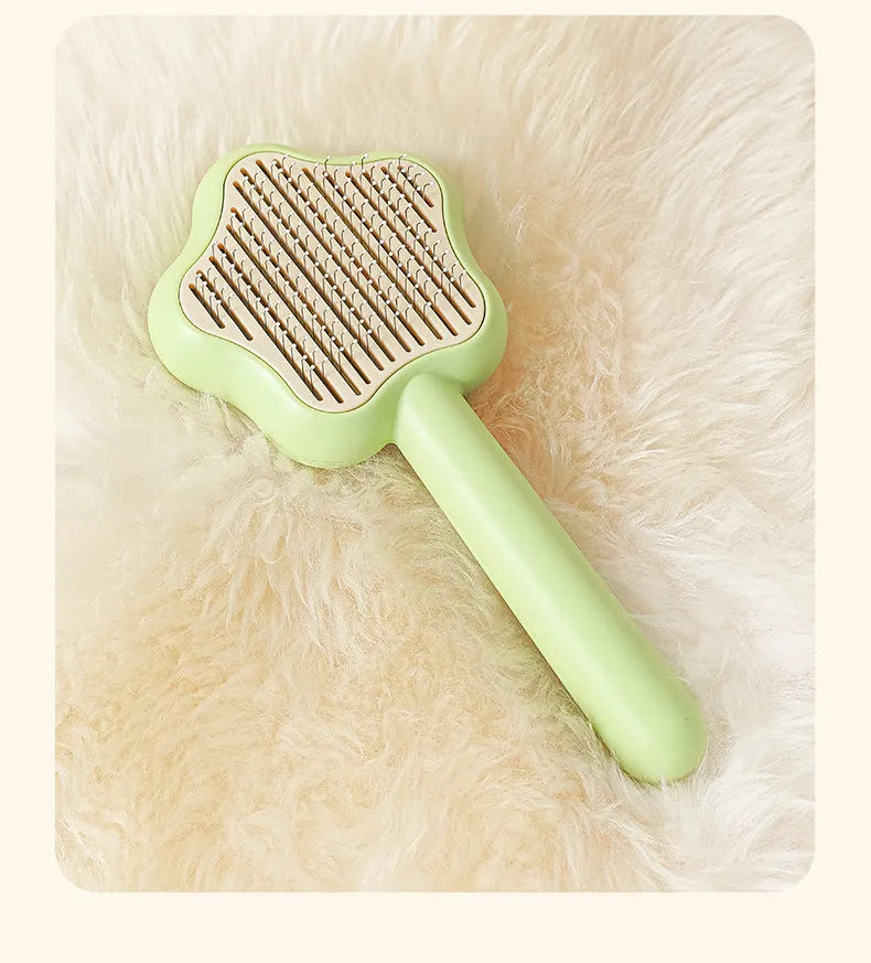 Green stainless steel cat grooming comb with self-cleaning mechanism and four rows of needles