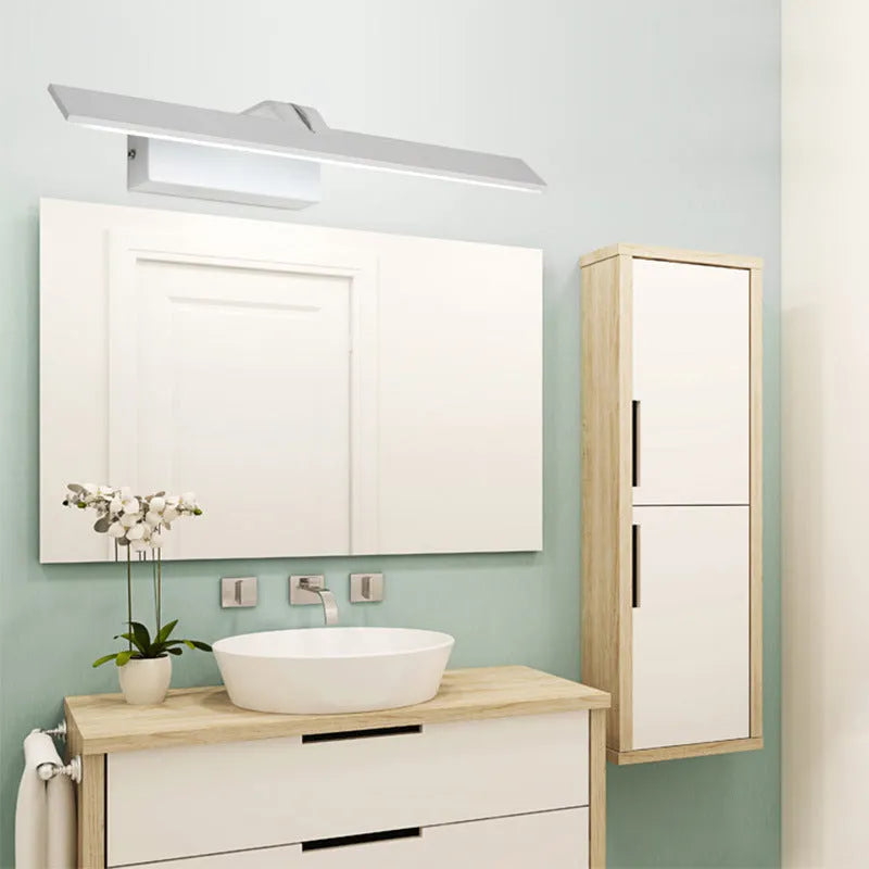 White framed LED illuminated bathroom mirror with integrated lighting mounted above bathroom basin