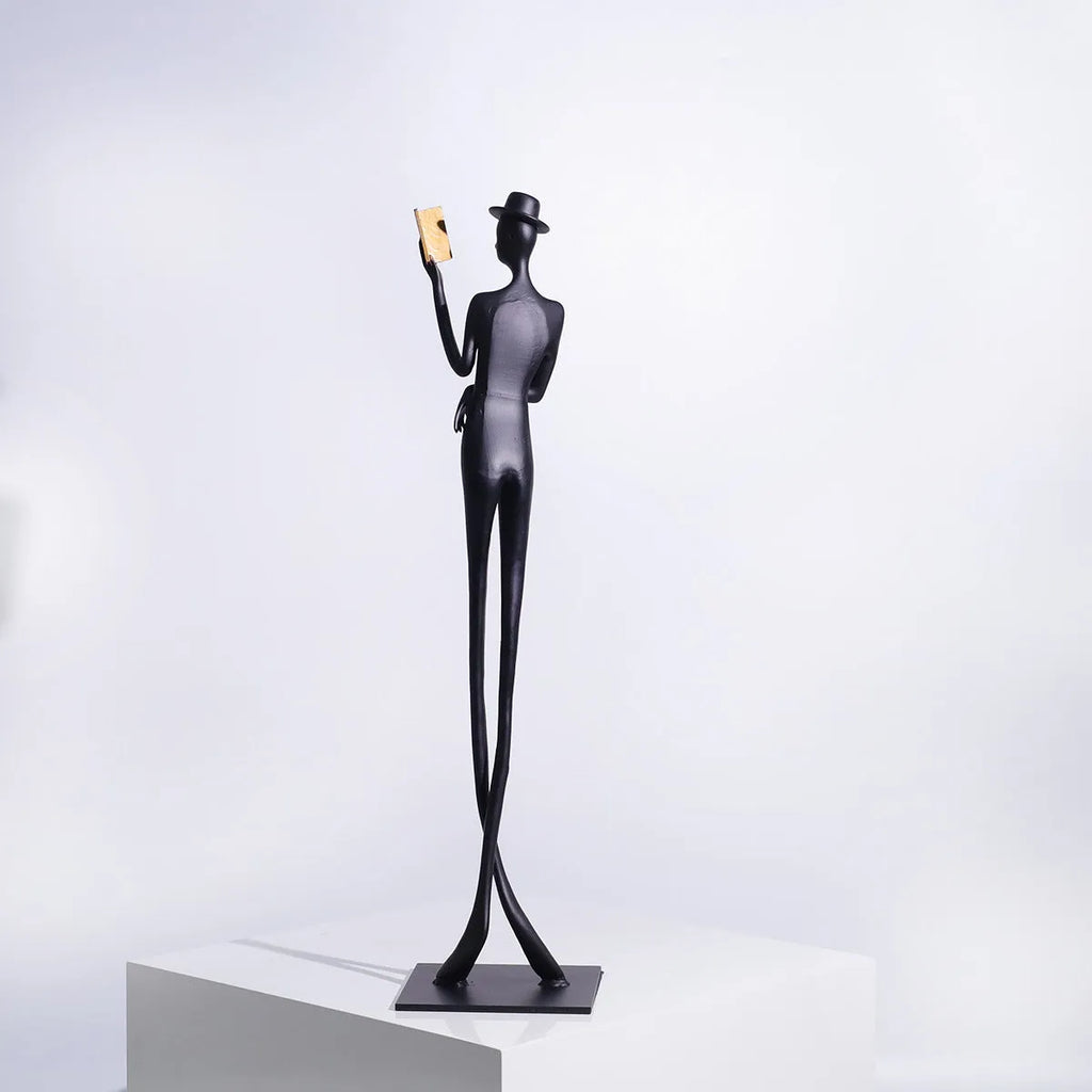 Black aluminium desktop sculpture of woman reading in modern style