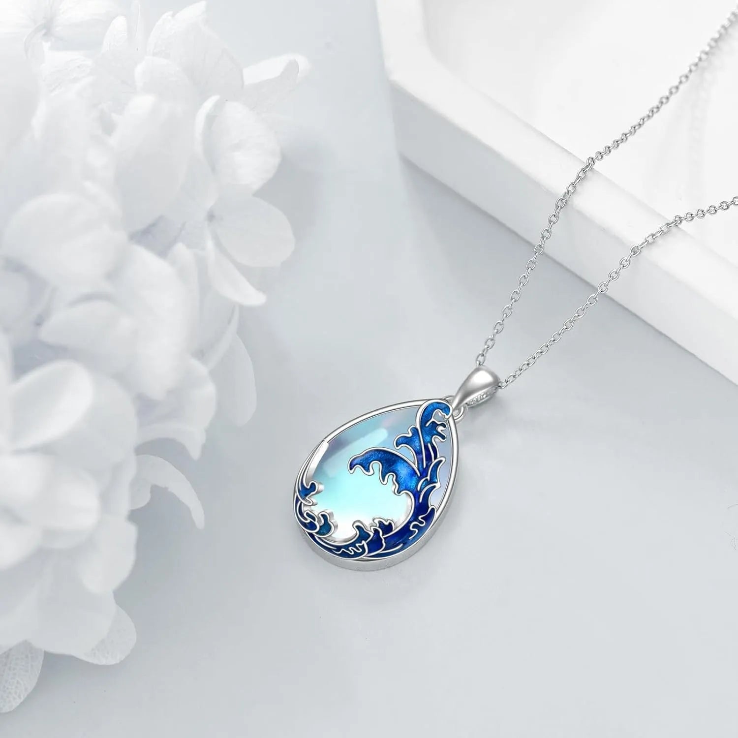 Blue alloy pendant necklace with heart design elements on included chain