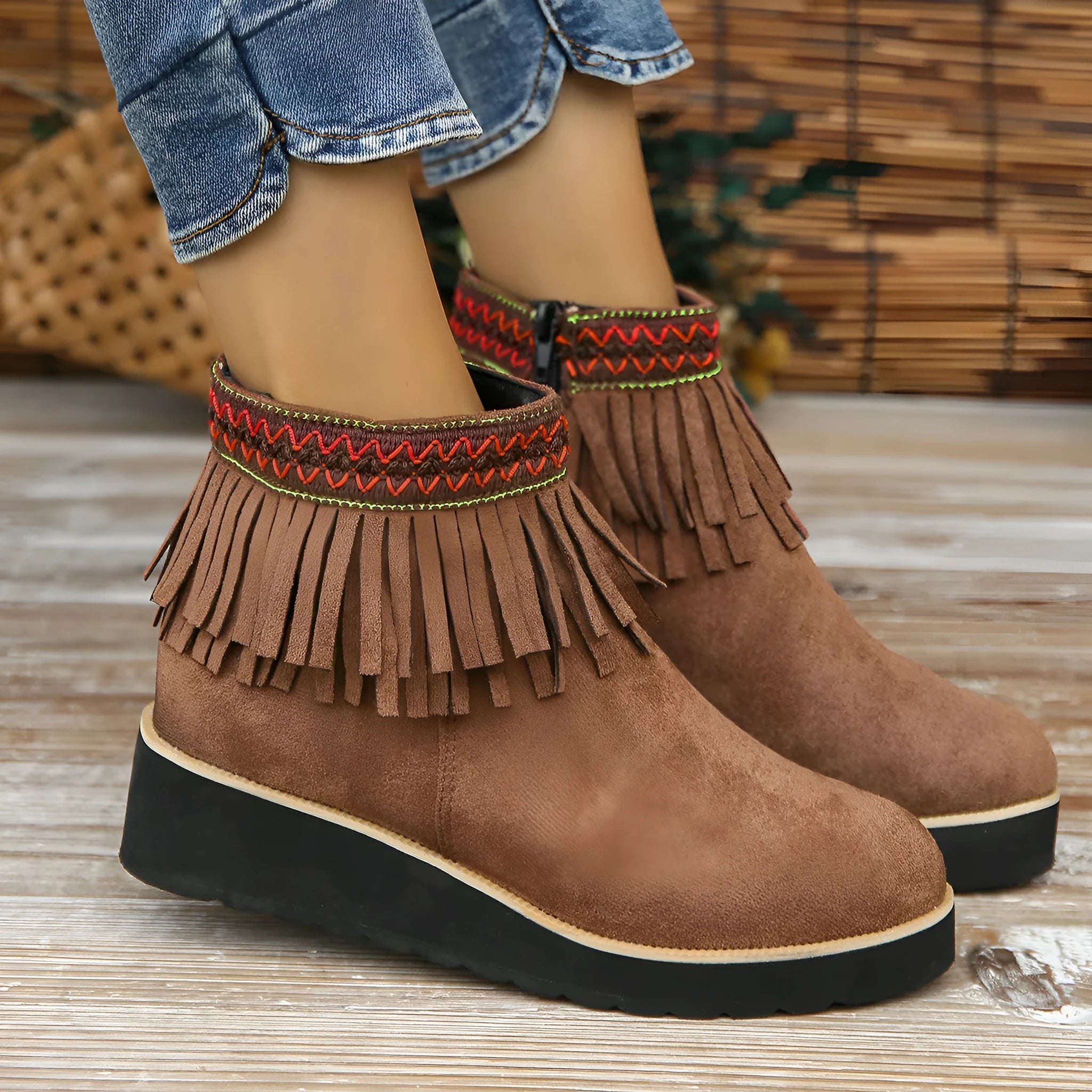 Women's dark brown suede wedge ankle boots with side zip and decorative tassel.