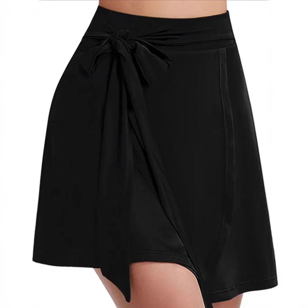 Black thigh-length sports culottes with built-in safety shorts and shoulder strap detailing