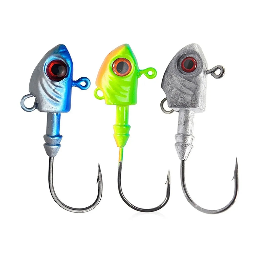 Simulation Yayu shaped lead head fishing jig hooks in blue, silver, yellow colours on a tackle background.