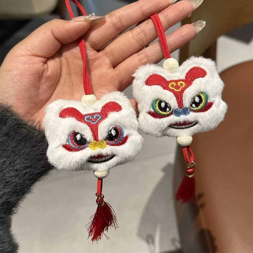 Chinese style plush lion keychain ornament with cartoon design and star stone details on blue background