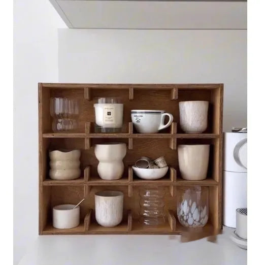Square solid wood storage rack with multiple grid compartments for cups and mugs in a birch wood finish.