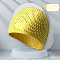 A solid colour silicone swimming cap for adults, shown in one of nine available colour options.