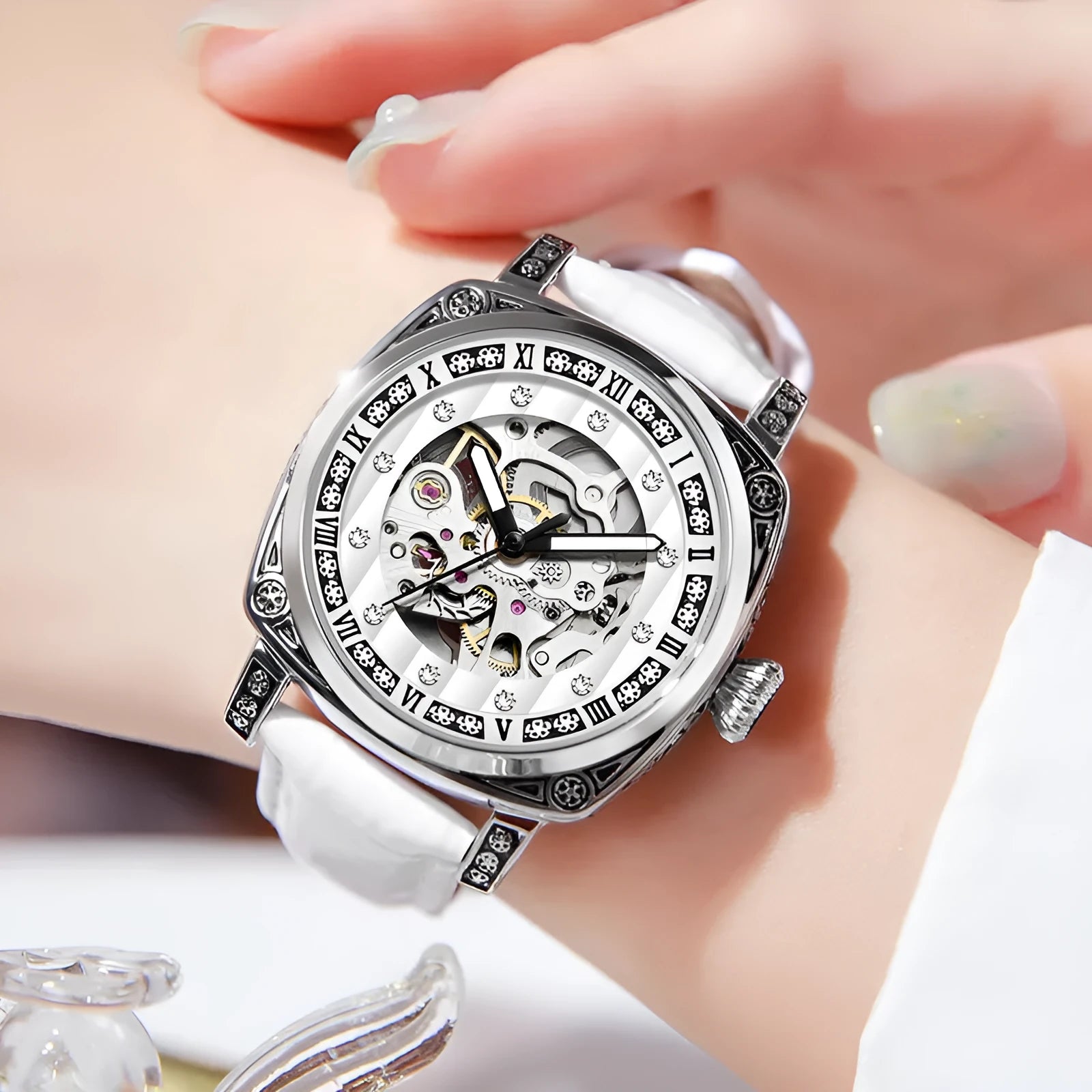 Men's black mechanical watch with luminous hands on a leather belt strap with needle detailing.