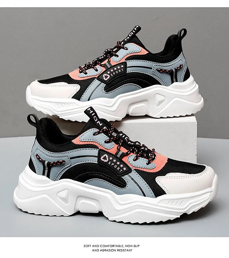White women's casual mesh sports shoe with thick sole, buckle detail, and round toe.