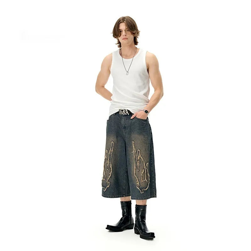 Men's black cotton denim shorts with flame embroidery detailing on straight cut casual design
