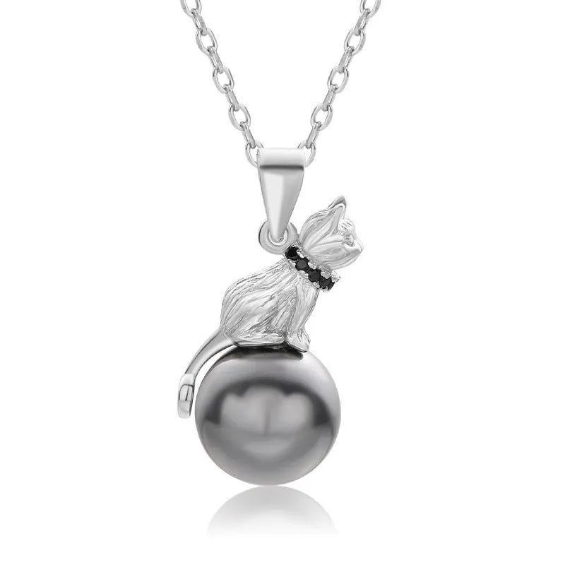 Close-up of a sterling silver cat pendant necklace on a clavicle-length chain, showing the electroplated finish.