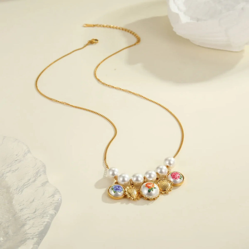 Vintage sunflower stainless steel necklace with 18K gold electroplated finish on display