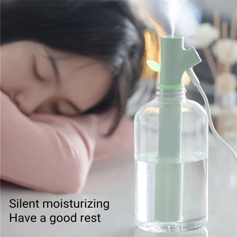 Transparent plastic USB portable humidifier with water tank showing mist output