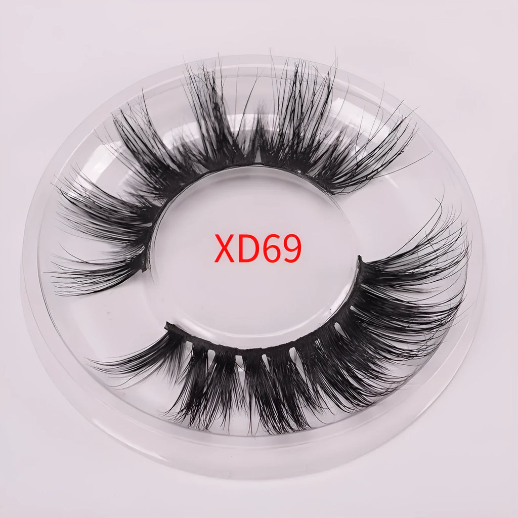 Handmade 5D mink false eyelashes set with brush and storage cap on a white background.