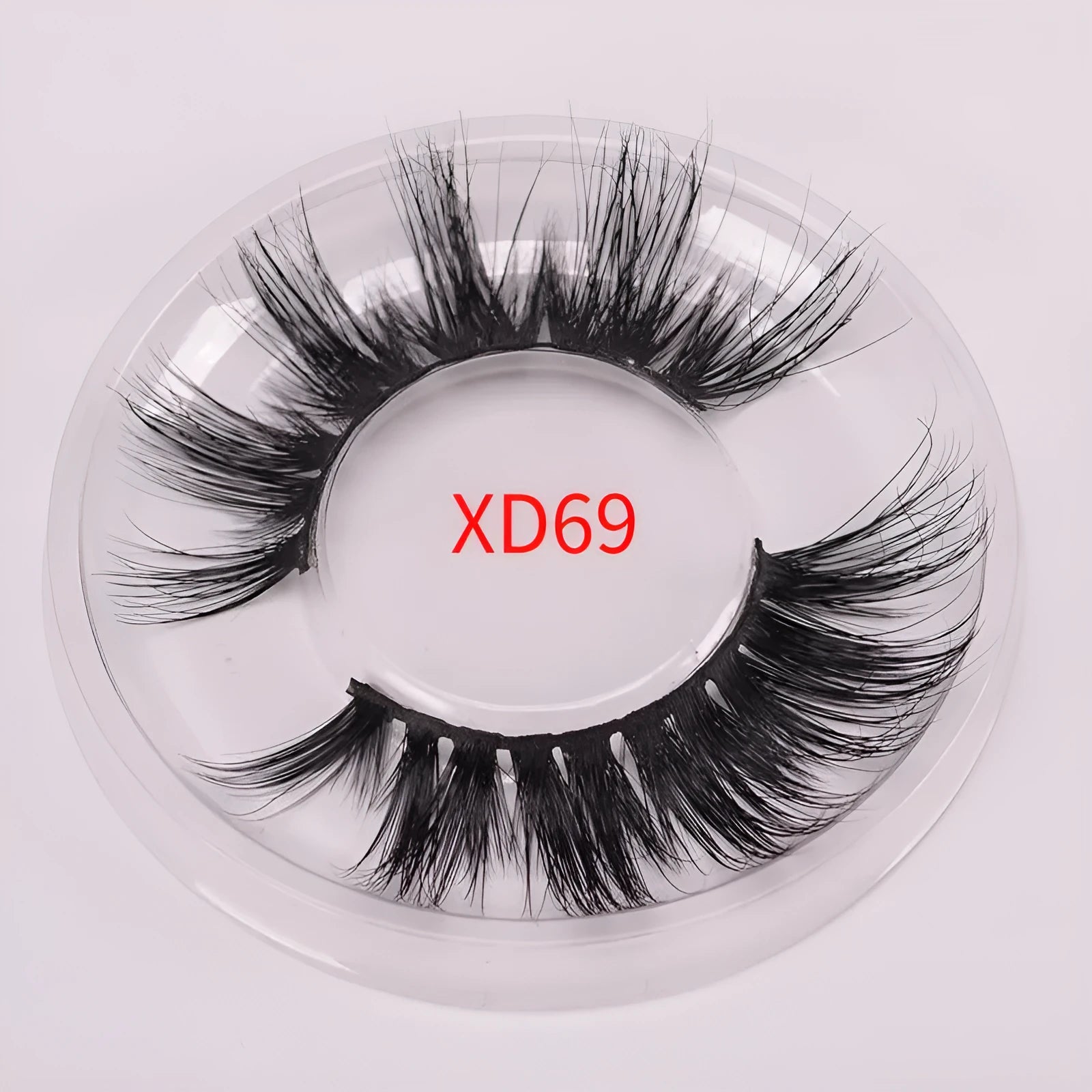Handmade 5D mink false eyelashes set with brush and storage cap on a white background.