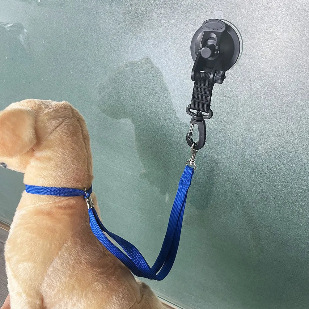Black and blue suction cup dog bath restraint kit with large and small cups on a tub.