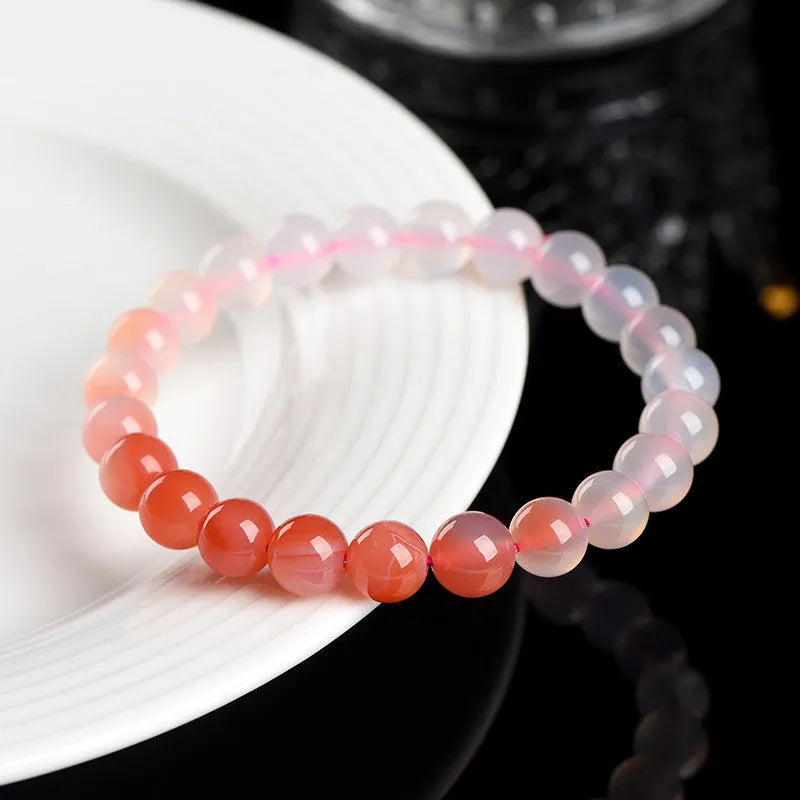 Natural gradient Yanyuan agate bracelet with geometric polished beads on a wrist, showing salt source colour variation.