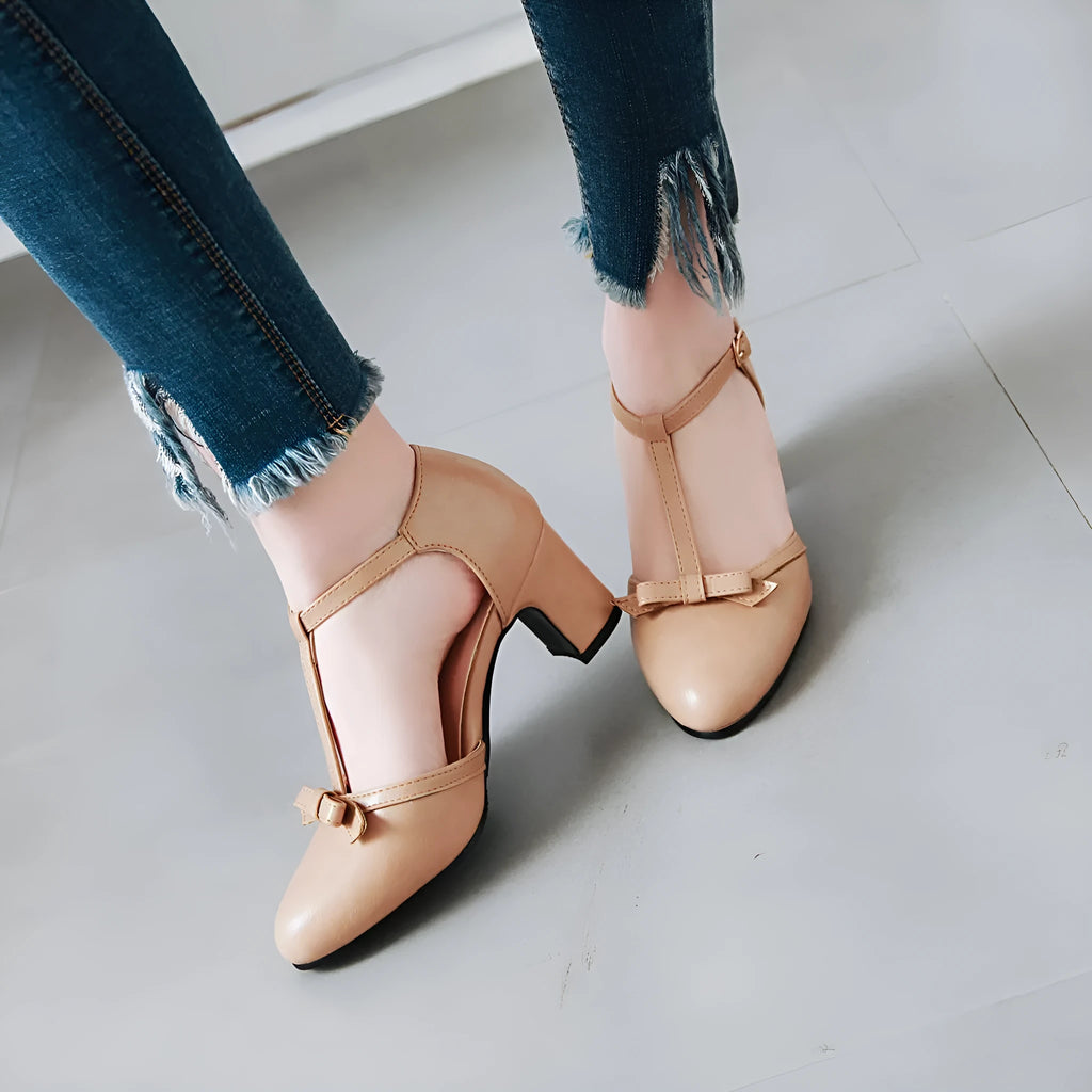 Women's apricot chunky heel sandals with buckle strap and bow detail on a hollow out PU upper.