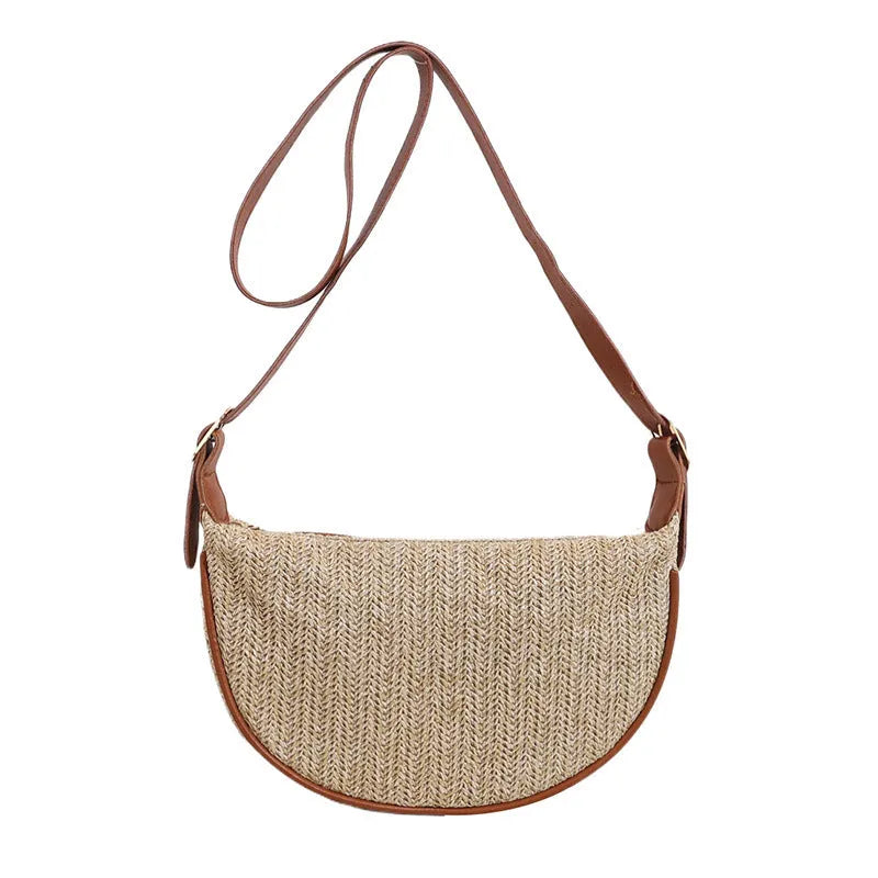 Women's woven straw crossbody bag with adjustable strap and interior organisation compartments