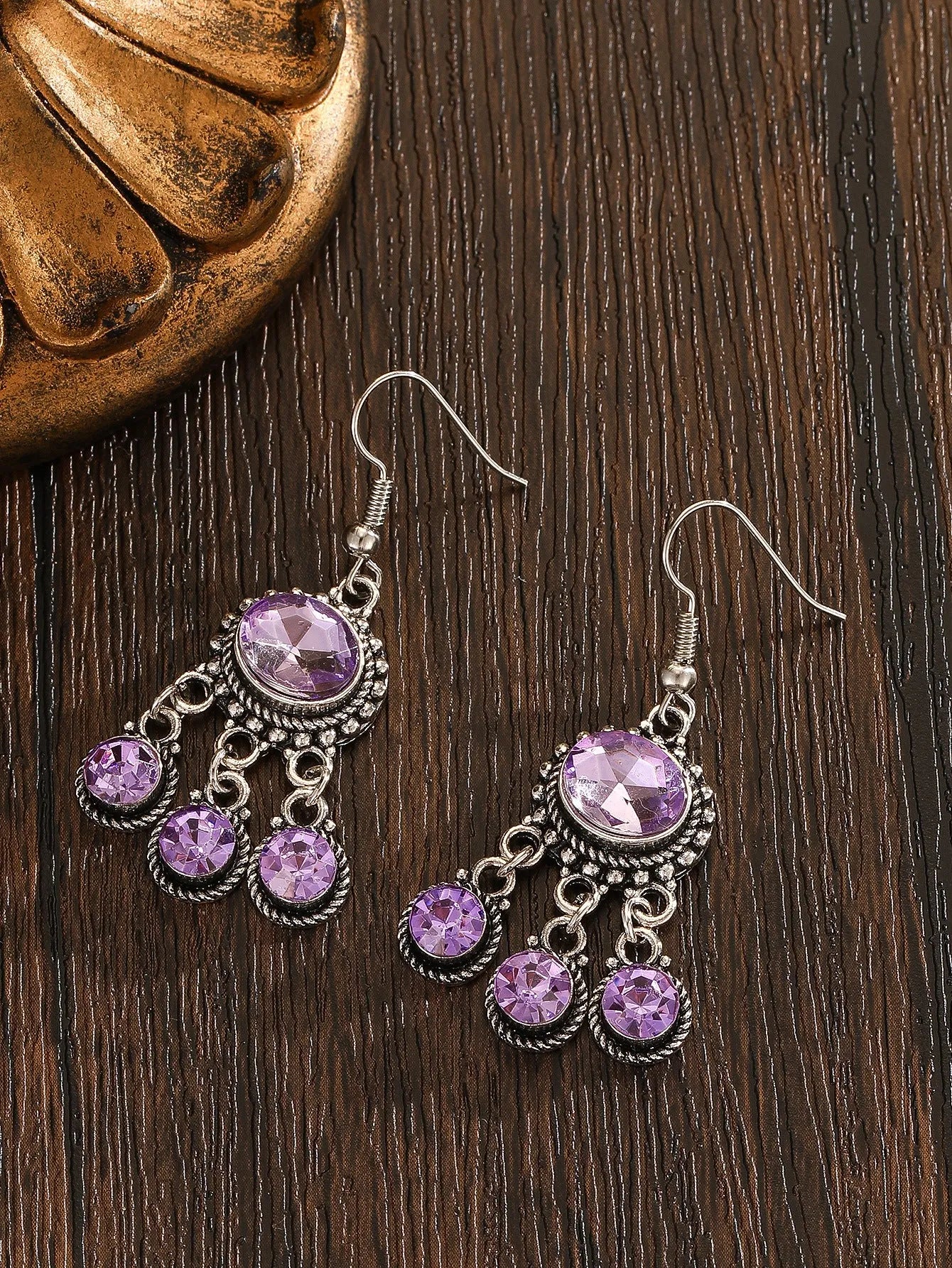 Long tassel alloy earrings in Dark Violet colour with hook fitting, hanging against a light background