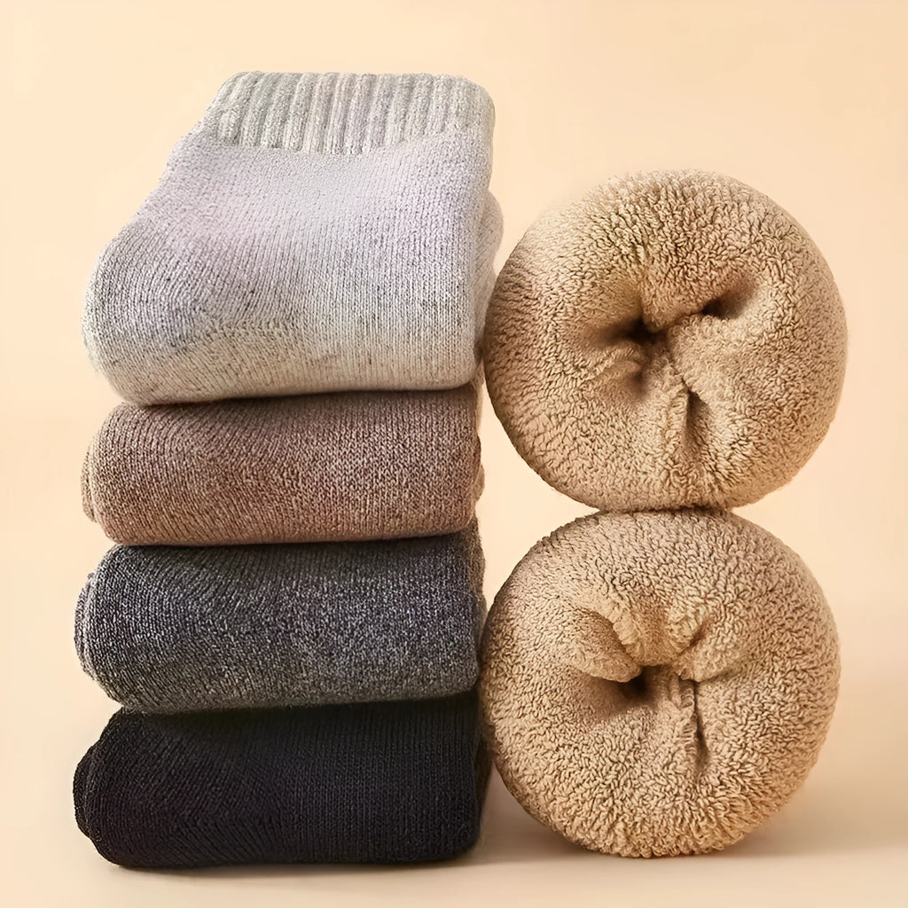A pair of thick, solid-colour merino wool winter socks with a visible cushioned midsole.