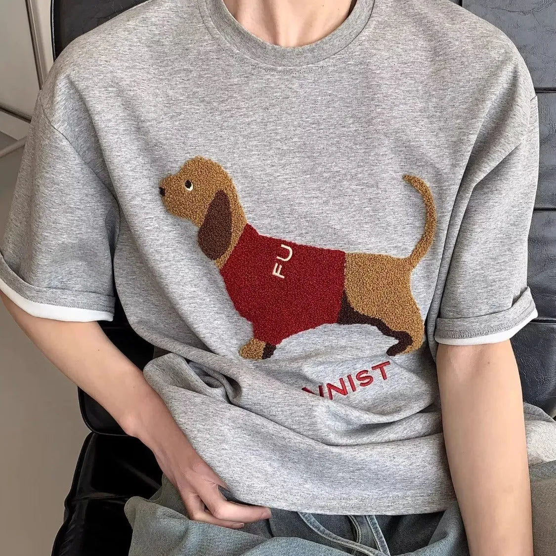 Grey men's t-shirt with an embroidered sausage dog design on the front.