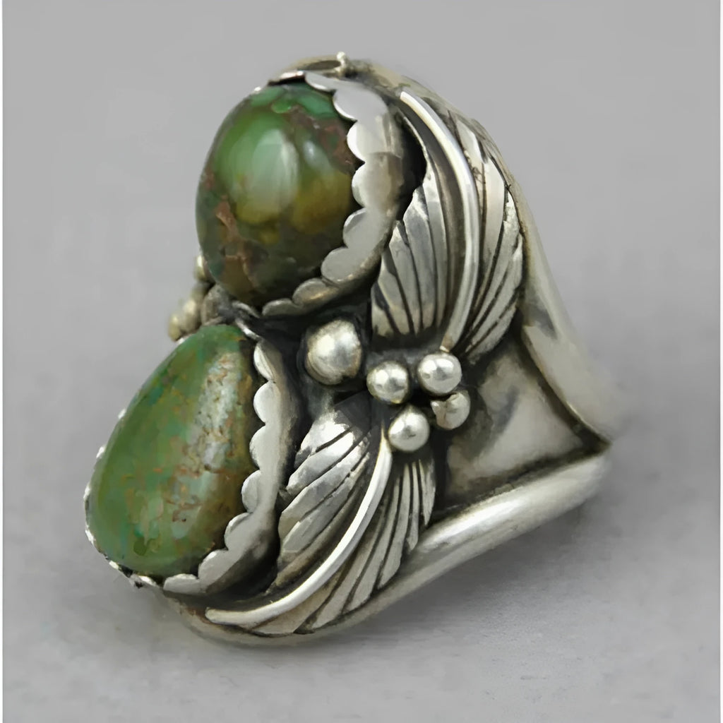Close-up of a turquoise geometric women's alloy ring on a hand, showing its angular shape and metallic finish.