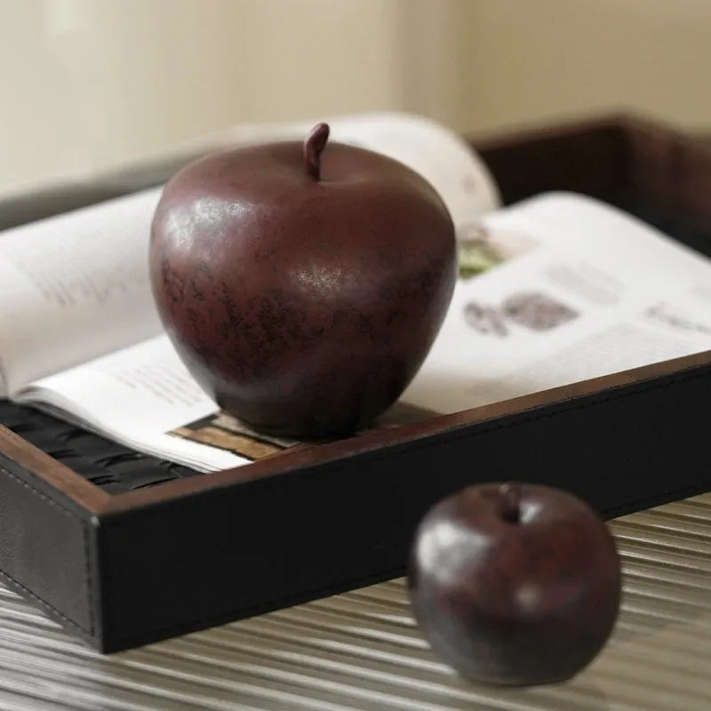 Retro style Chinese ceramic apple decoration ornament on a desktop.