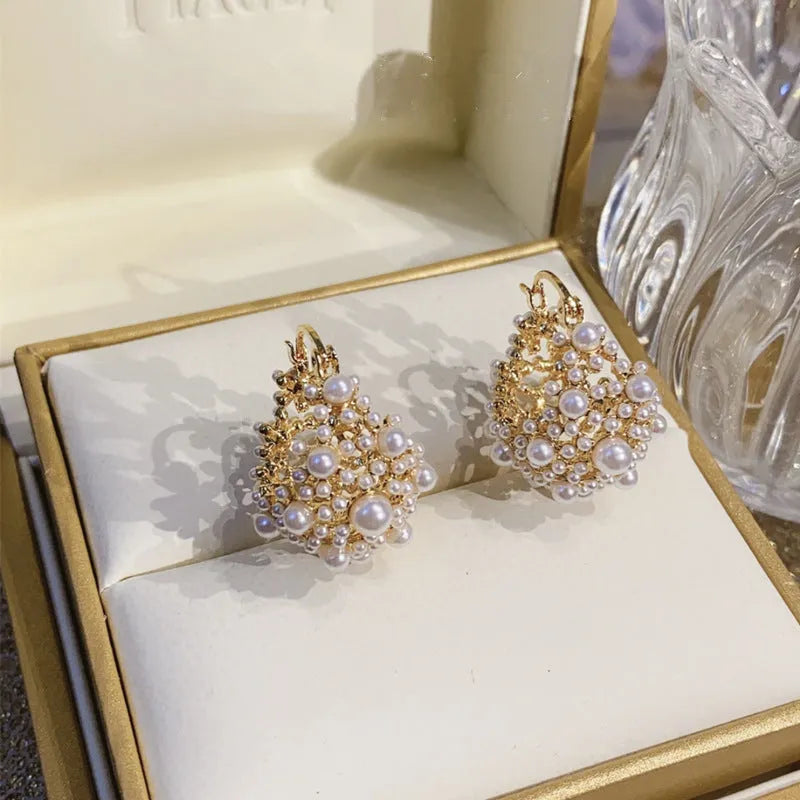Gold colour women's floral basket design earrings with small beads and pearl inlay on copper