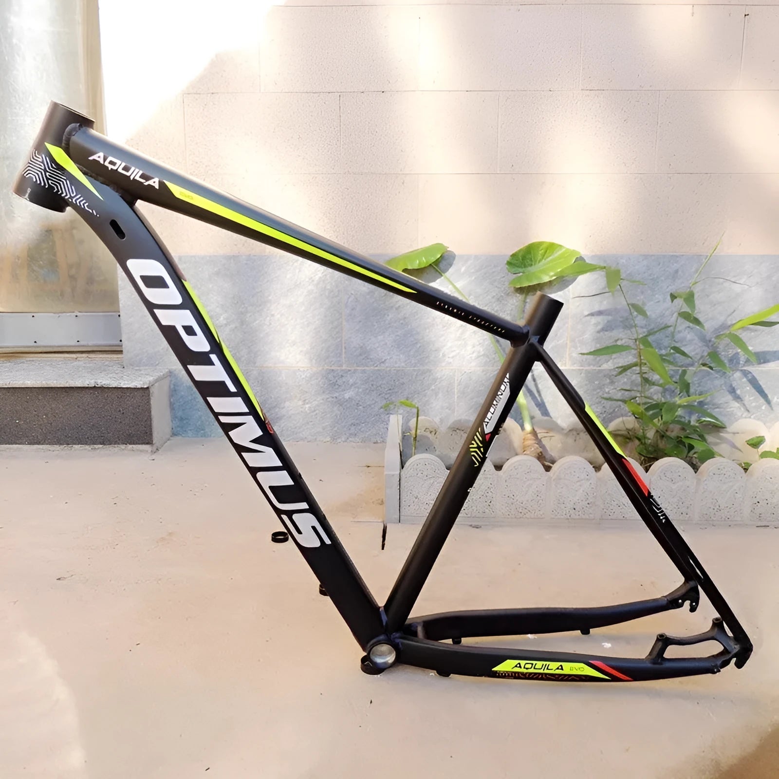 Black green 29-inch aluminium mountain bike frame with internal cable routing and disc brake mounts.