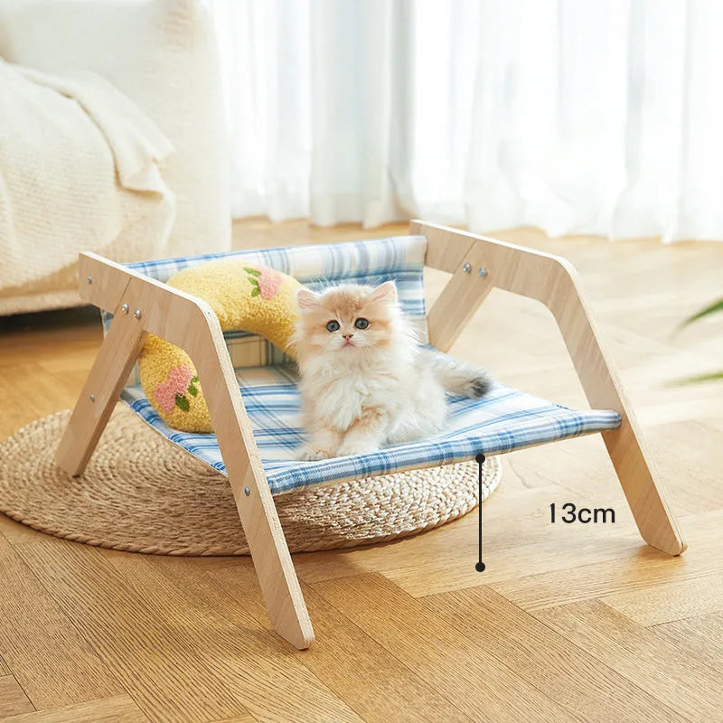 Wooden elevated cat bed with blue cloth hammock in beach chair design for indoor cats