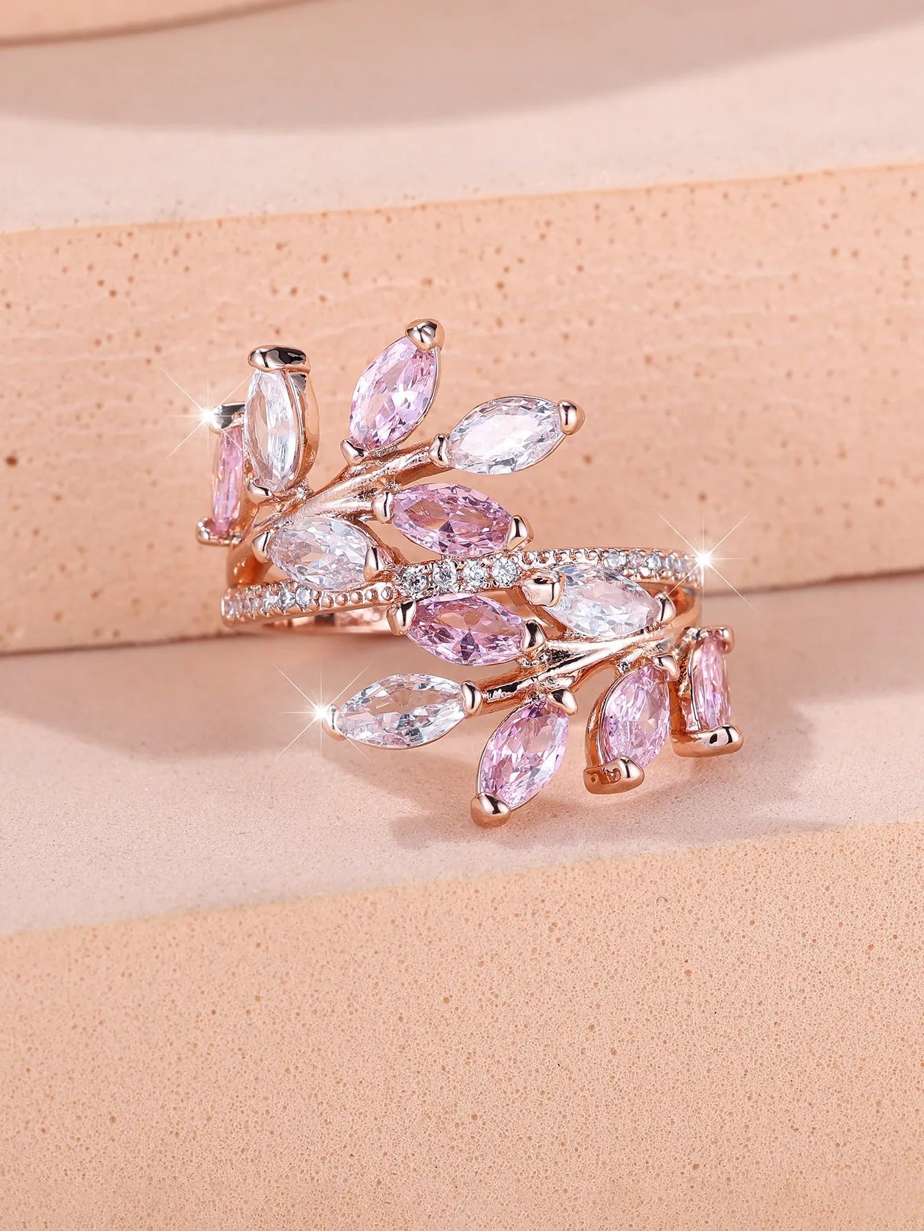 Adjustable horse eye design leaf ring in copper with zircon crystals, shown in a rose gold finish
